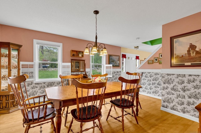 686 W Rd, Salem, CT 06420 - dining space with wallpapered walls, light wood-style floors, a chandelier, and baseboards