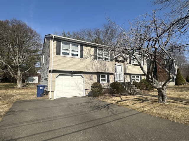 split foyer home with a garage and driveway