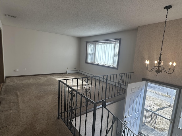 staircase featuring baseboards, visible vents, carpet floors, an inviting chandelier, and a textured ceiling