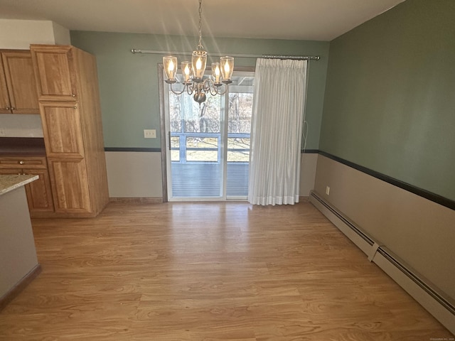 unfurnished dining area with an inviting chandelier, baseboards, light wood-type flooring, and a baseboard radiator