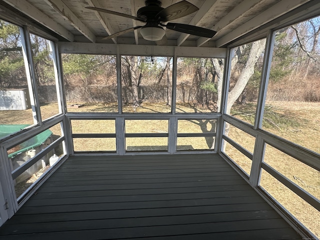 unfurnished sunroom with a ceiling fan