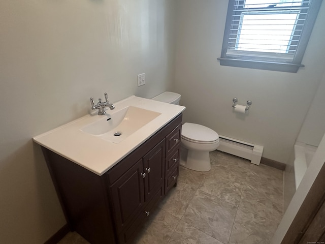 full bathroom featuring a baseboard heating unit, toilet, vanity, and baseboards