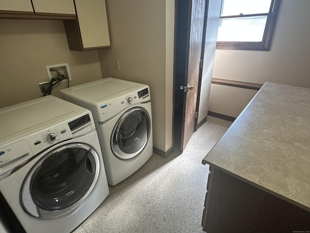 laundry area with cabinet space, baseboards, and washer and clothes dryer