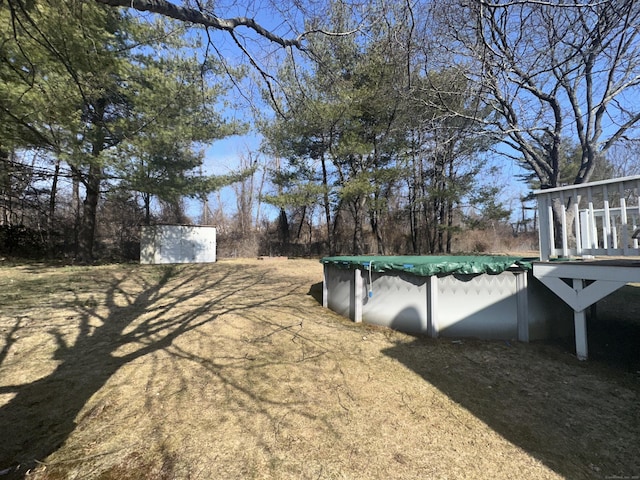 view of yard with a covered pool