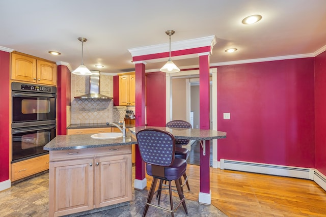 kitchen with ornamental molding, a sink, black appliances, dark countertops, and wall chimney range hood