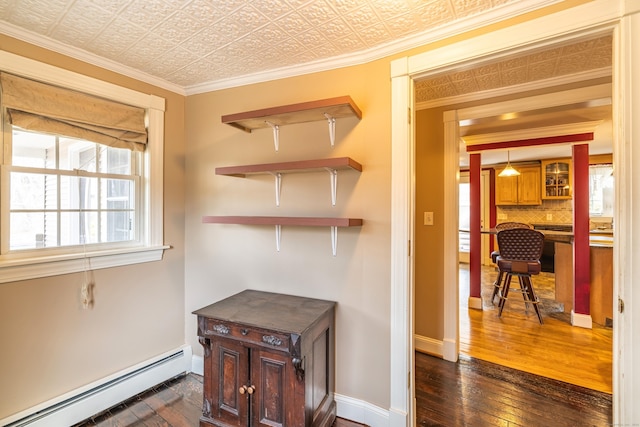 interior space featuring crown molding, baseboards, dark wood finished floors, an ornate ceiling, and a baseboard radiator