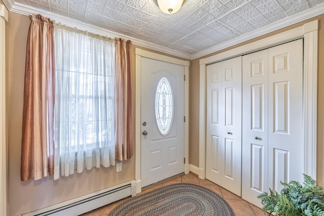 foyer with light tile patterned floors, ornamental molding, an ornate ceiling, and a baseboard radiator