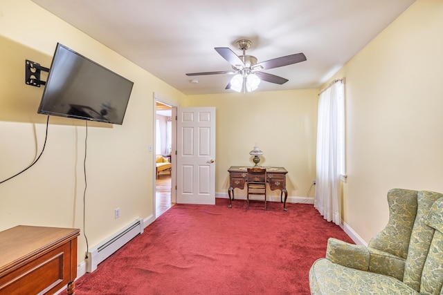 sitting room featuring a baseboard heating unit, carpet floors, baseboards, and ceiling fan