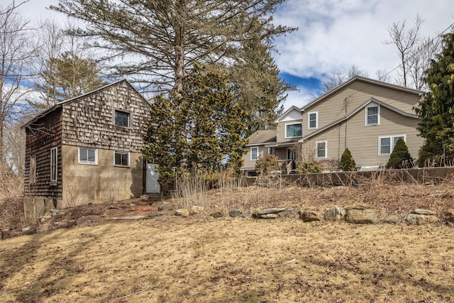 rear view of property featuring fence