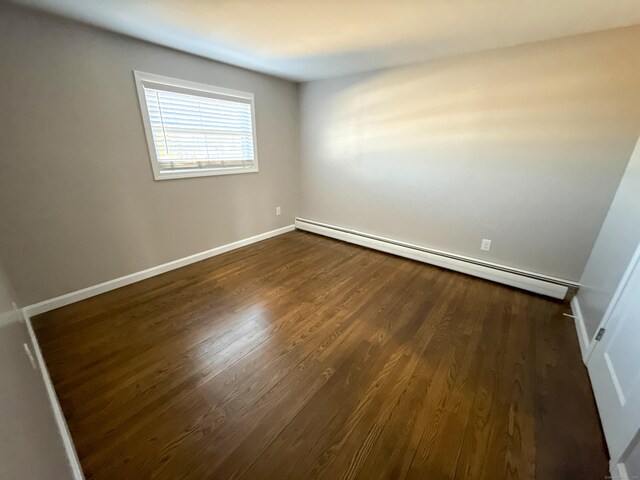223 Rte 169, Woodstock, CT 06281 - empty room featuring dark wood finished floors, baseboard heating, and baseboards