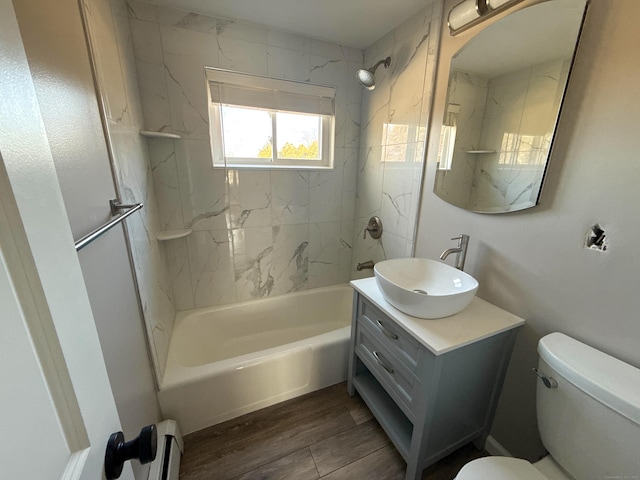 223 Rte 169, Woodstock, CT 06281 - full bath with toilet, vanity, wood finished floors, washtub / shower combination, and a baseboard radiator