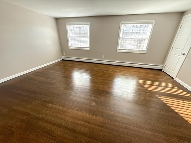 223 Rte 169, Woodstock, CT 06281 - spare room featuring a wealth of natural light, baseboard heating, dark wood-type flooring, and baseboards