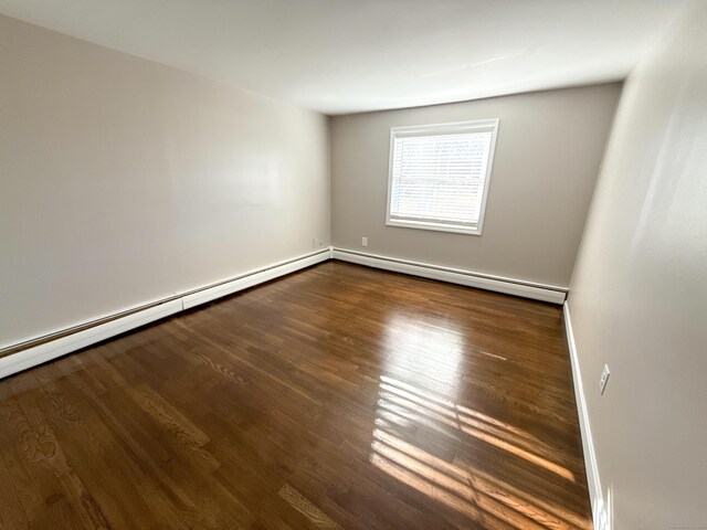 223 Rte 169, Woodstock, CT 06281 - empty room with dark wood-style floors, baseboard heating, and baseboards
