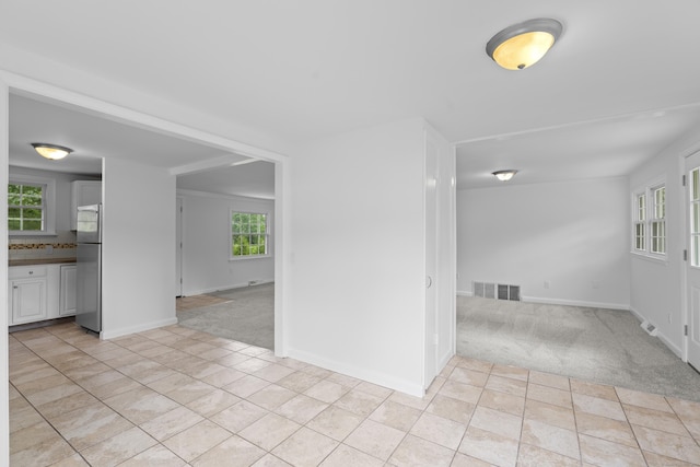 26 Oconnell Rd, East Haddam, CT 06423 - unfurnished room with light carpet, light tile patterned floors, and baseboards
