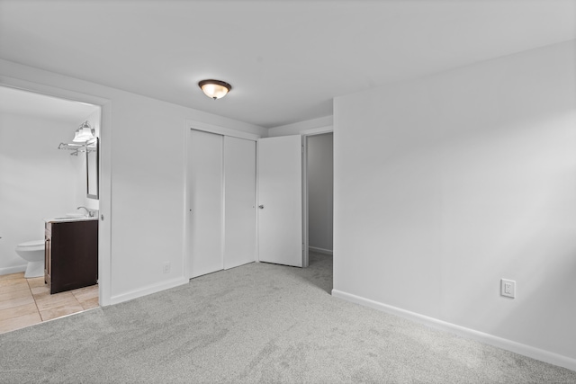 26 Oconnell Rd, East Haddam, CT 06423 - unfurnished bedroom with light colored carpet, baseboards, a closet, and ensuite bath