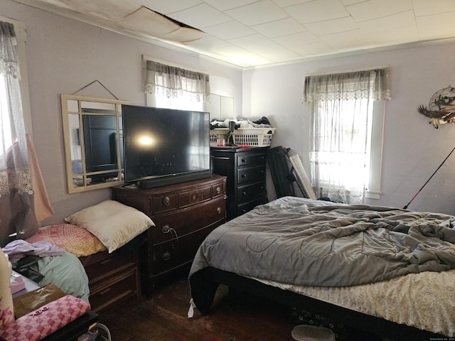 bedroom featuring wood finished floors and ornamental molding