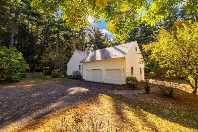 view of home's exterior with a garage and driveway