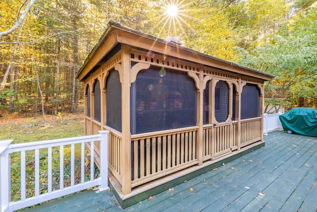 deck with a sunroom and grilling area