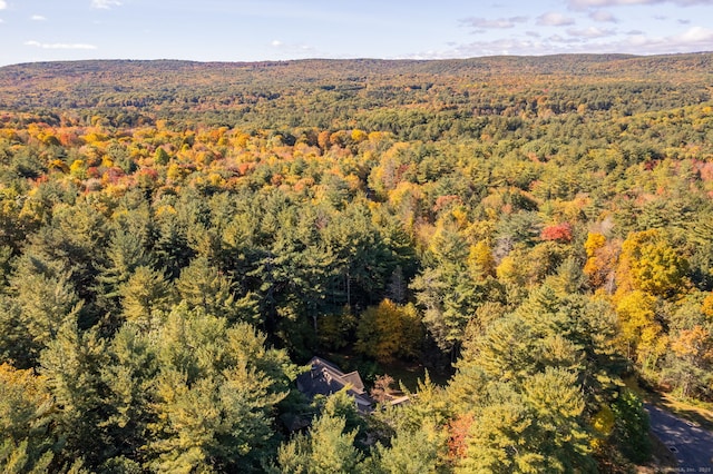 drone / aerial view with a wooded view