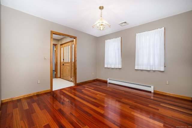 unfurnished room featuring visible vents, a baseboard heating unit, baseboards, a chandelier, and wood finished floors