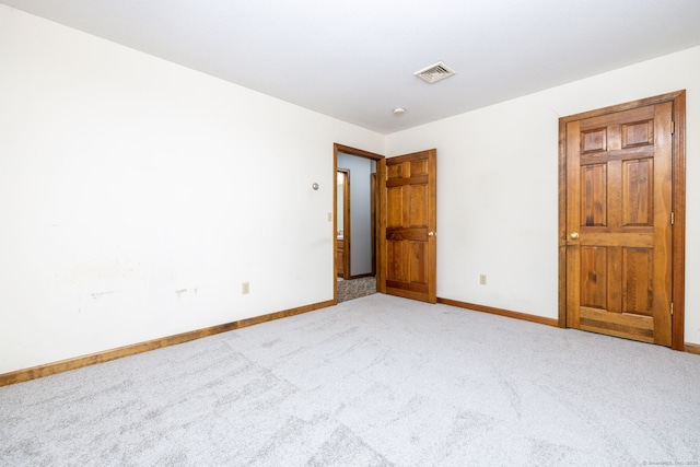 unfurnished bedroom featuring baseboards, visible vents, and carpet floors