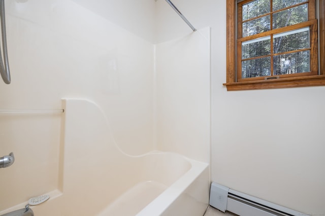 bathroom with baseboard heating and shower / bathtub combination