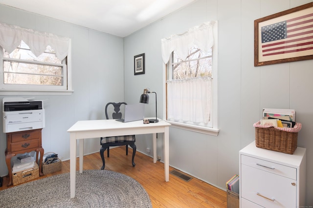 home office with light wood finished floors and visible vents