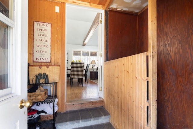 corridor with beam ceiling and wood finished floors