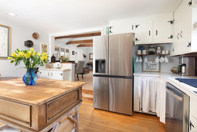 kitchen with white cabinetry, appliances with stainless steel finishes, light wood-style flooring, and light countertops