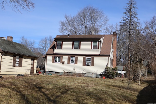 view of front of house with a chimney and a front yard