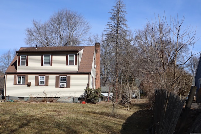 exterior space featuring a yard and a chimney