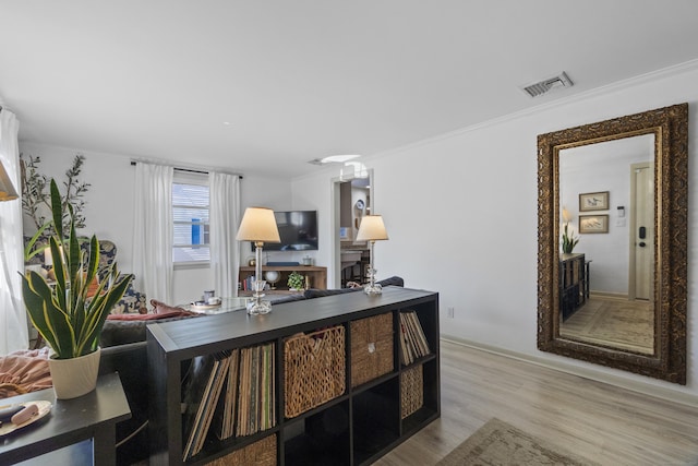 office space featuring wood finished floors, visible vents, and ornamental molding