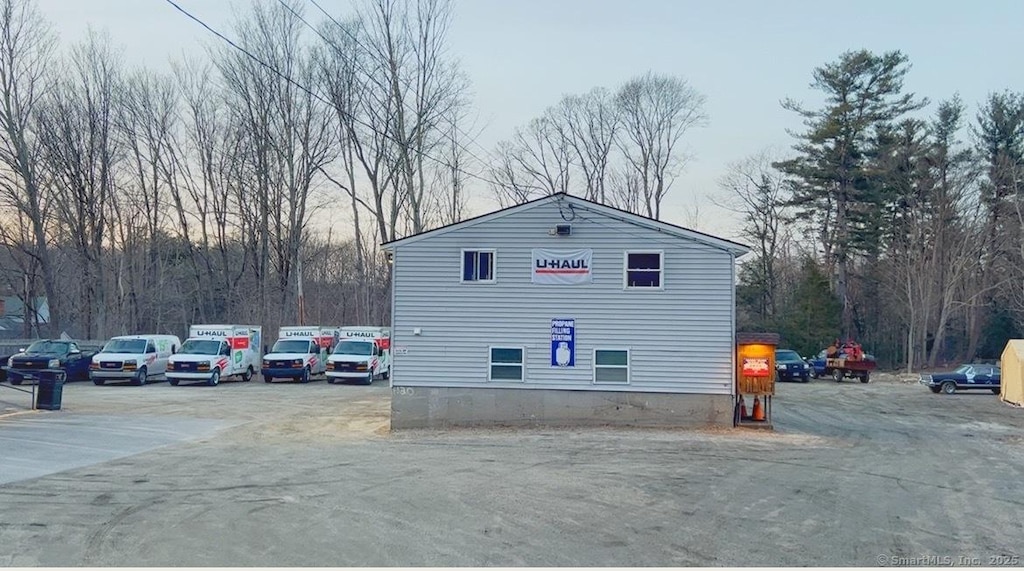 view of side of home featuring uncovered parking