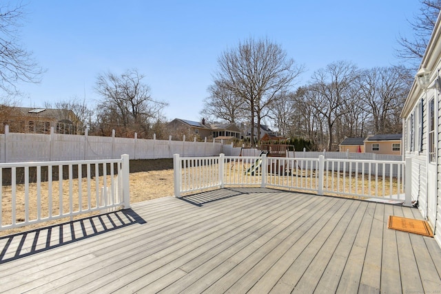 wooden terrace with a fenced backyard and a residential view