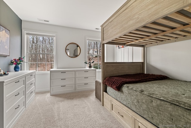 bedroom with visible vents and light colored carpet