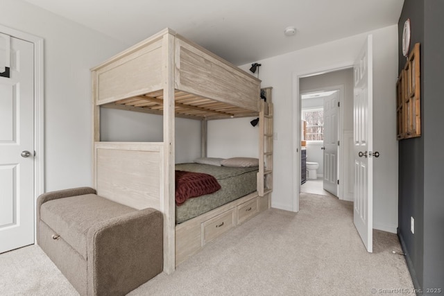 bedroom with light colored carpet and baseboards