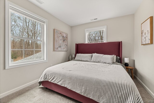 bedroom with carpet flooring, baseboards, and visible vents