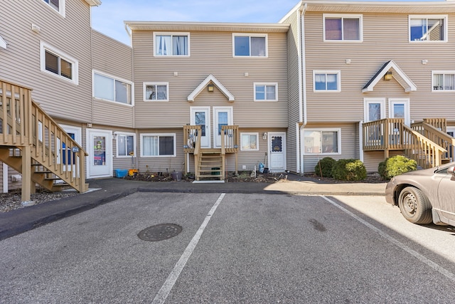 exterior space featuring stairway and uncovered parking