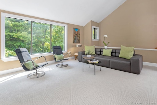 carpeted living room featuring vaulted ceiling and baseboards