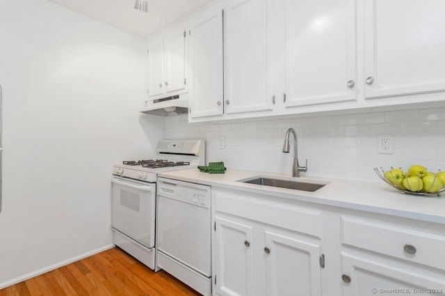 kitchen with a sink, under cabinet range hood, white cabinetry, white appliances, and light countertops