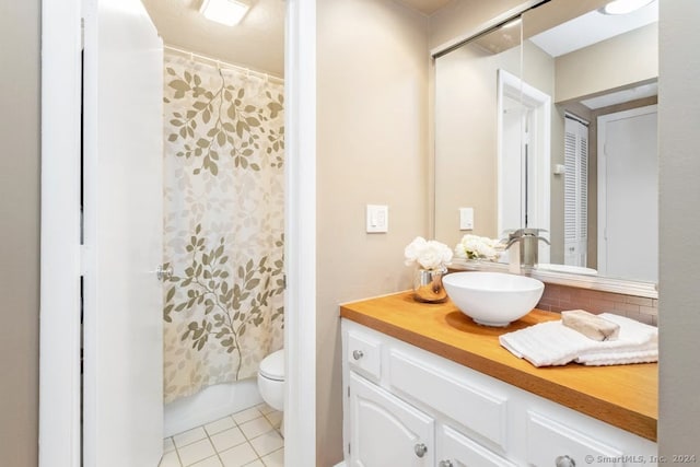 bathroom featuring shower / bath combination with curtain, tile patterned floors, vanity, and toilet