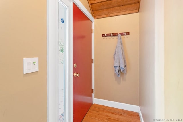 corridor featuring wood finished floors and baseboards