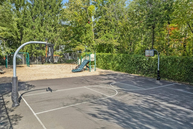 view of sport court featuring community basketball court and playground community