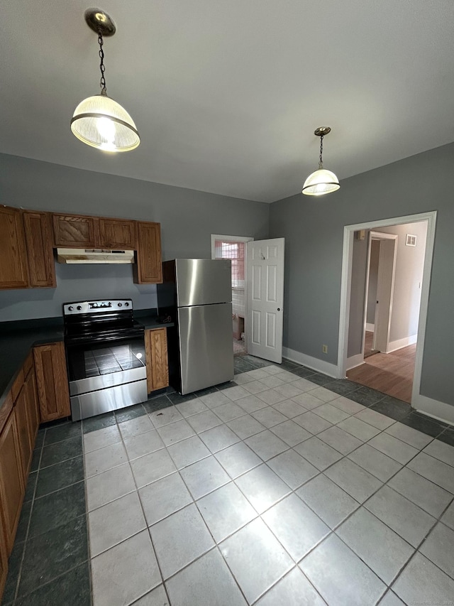 kitchen featuring dark countertops, stainless steel appliances, and brown cabinetry