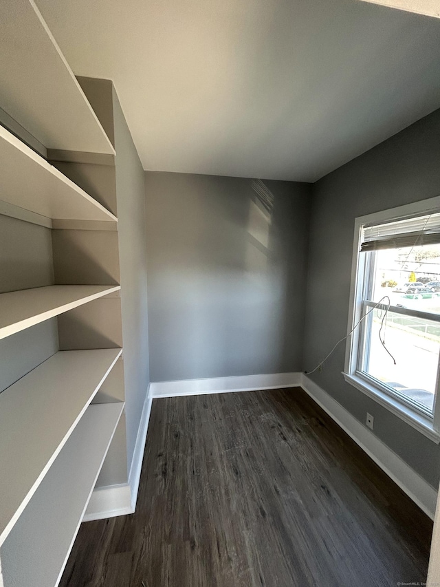 interior space with baseboards and dark wood finished floors