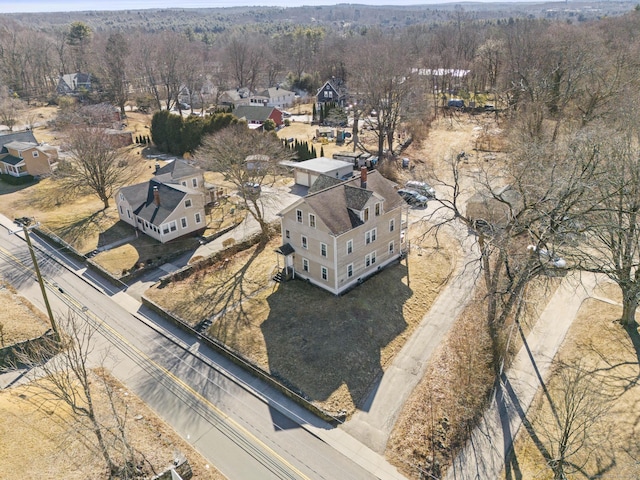 drone / aerial view featuring a forest view and a residential view