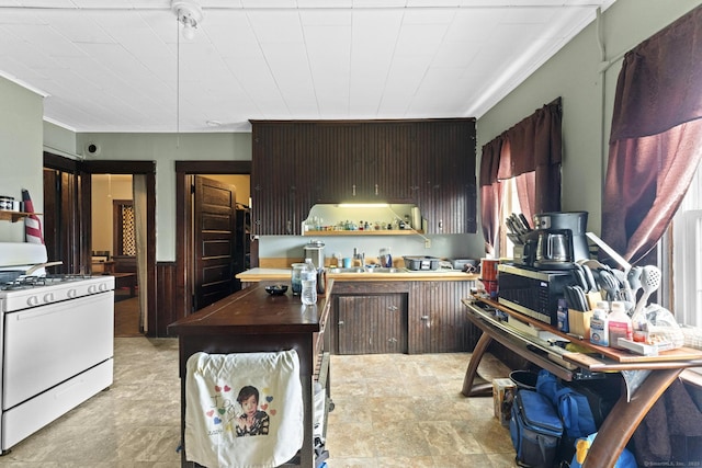 kitchen with wood counters and white gas stove