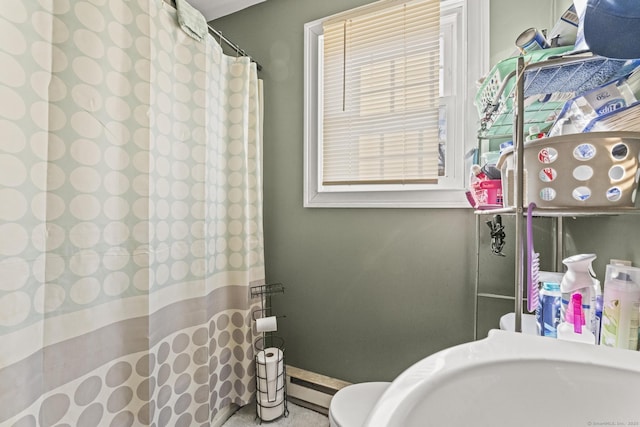 full bath with a baseboard heating unit and a shower with shower curtain