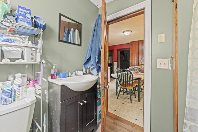 bathroom featuring toilet, vanity, and wood finished floors