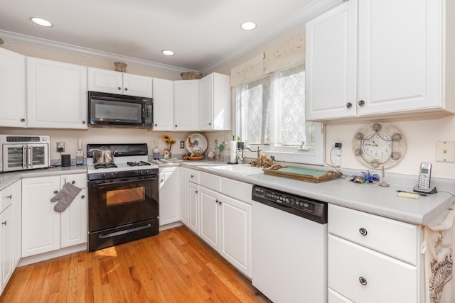 kitchen with gas stove, black microwave, light countertops, crown molding, and dishwasher